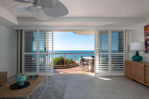 a living room with a view of the ocean at Beachfront Villa in Coolum Beach