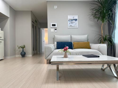 a living room with a couch and a coffee table at Eunhasu D&M Residence in Daejeon