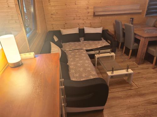 a room with a couch and a table and chairs at Domek Nad Morzem in Kołobrzeg