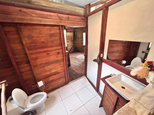 a bathroom with a toilet and a sink at Coco cabañas Tela in El Triunfo de la Cruz