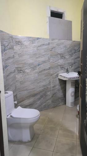 a bathroom with a toilet and a sink at hotel shiv bliss inn Dibai in Dibai