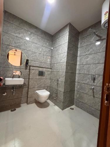 a bathroom with a toilet and a sink and a shower at Hotel Shree Amrit Ganga in Haridwār