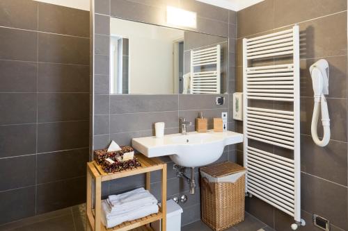 a bathroom with a sink and a mirror at Affittacamere Polvara Trentuno in Lecco