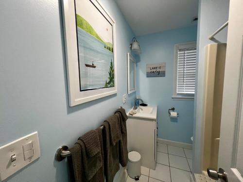 a bathroom with a sink and a toilet with towels at Dockside Dreamz 2 with beach & dock in Clarksville