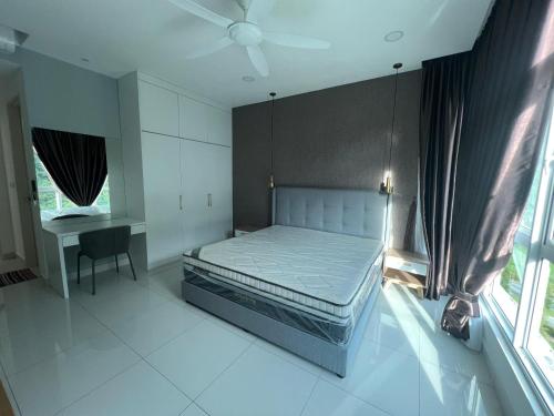a bedroom with a bed and a desk and a window at Homestays Batu Ferringhi in Batu Ferringhi
