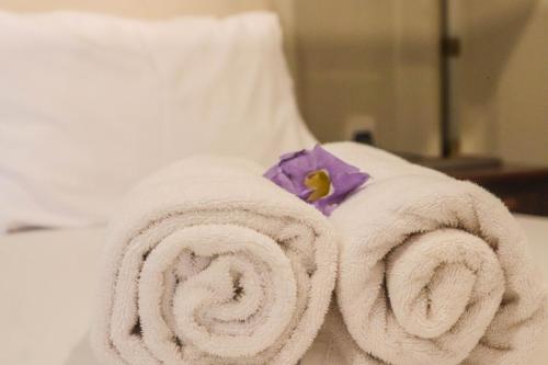 a pile of towels sitting on top of a bed at Unawa Retreat in Tissamaharama