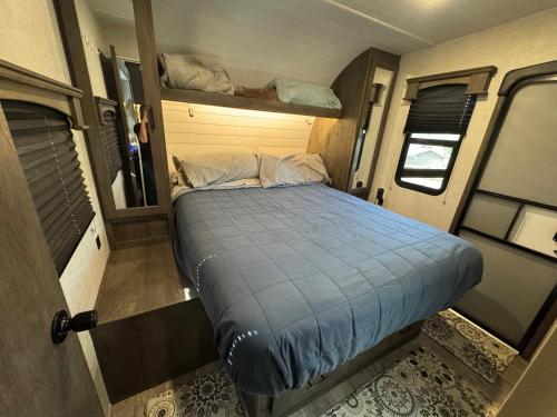 a small bed in the back of a rv at Waxberry Trailer by Kings Canyon and Sequoia National Parks in Squaw Valley