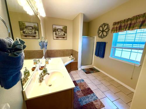 a bathroom with a sink and a shower and a tub at Rockwood Condos on Table Rock Lake With Boat Slips in Branson