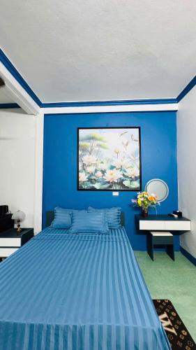 a blue bedroom with a large blue bed in it at Favos Bích Động in Vũ Lâm