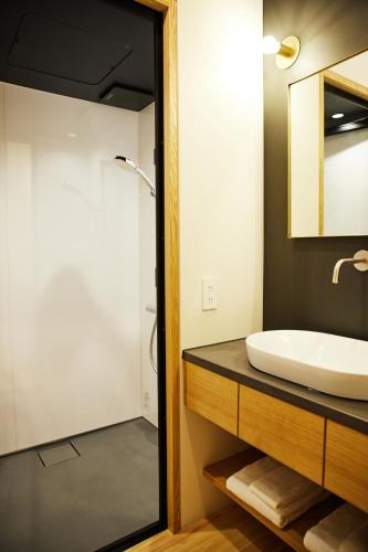 a bathroom with a sink and a mirror at 蔵宿あさぎやみたけ in Ome