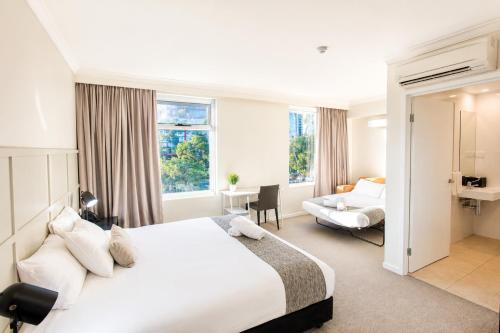 a hotel room with a bed and a desk at Woodroffe Hotel in Gold Coast