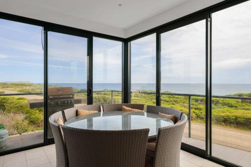 a dining room with a view of the ocean at Amazing Ocean Views with Spa in Surf Beach