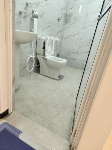 a bathroom with a toilet and a sink at Trinco salli beach resort in Trincomalee