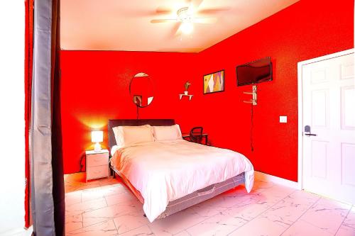 a red bedroom with a bed and a red wall at Private Guestrooms OR Entire Home Rental in North Las Vegas in Las Vegas