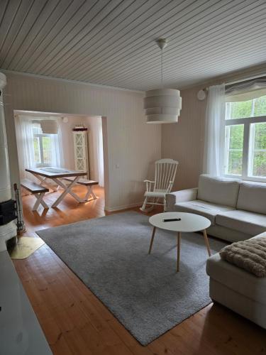 a living room with a couch and a table at Linnansalmi Lakeside Villa with Sauna in Savonlinna
