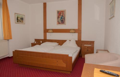 a bedroom with a bed and a table in a room at Gasthof Hofbauer in Schwanenstadt
