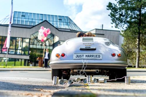 a man and a woman in a hot car on the street at Best Western Plus Parkhotel Velbert in Velbert