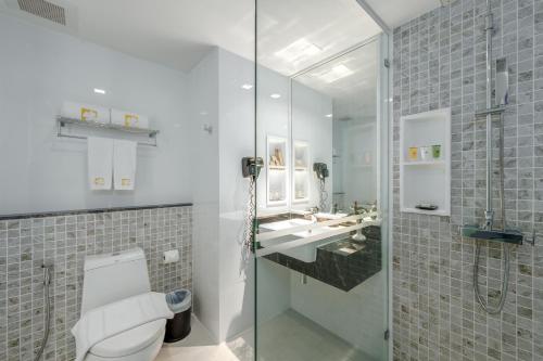 a bathroom with a toilet and a sink and a shower at Hotel Clover Patong Phuket in Patong Beach