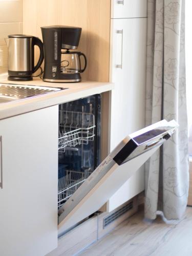 a dishwasher in a kitchen next to a refrigerator at Ferienwohnung Lange in Göstling an der Ybbs