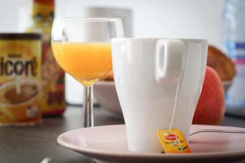 a cup of coffee and a glass of orange juice at R&eacute;sidence les C&egrave;dres in Strasbourg