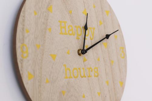 a clock with the words happy hours written on it at Résidence les Cèdres in Strasbourg