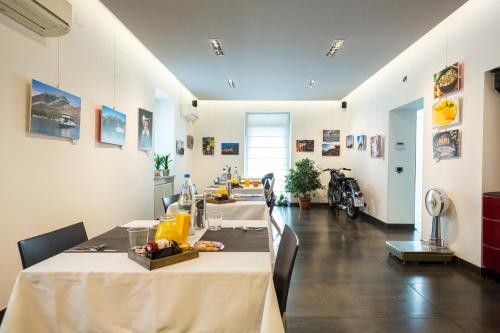 a dining room with two tables and a room with at Affittacamere Polvara Trentuno in Lecco