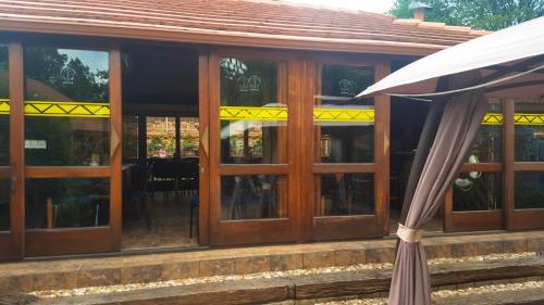 an umbrella sitting in front of a building with windows at Aark Guest Lodge in Vanderbijlpark