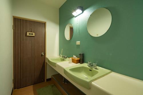 a bathroom with a sink and a mirror at TANIGAWA GOODY Lodge in Minakami