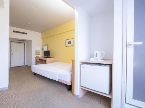 a bedroom with a white bed and a desk at Chisun Inn Nagoya in Nagoya