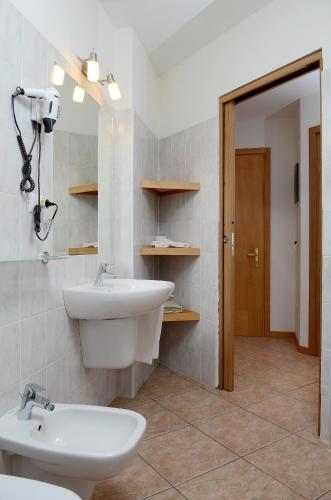 a bathroom with a sink and a mirror at Ski Residence in San Martino di Castrozza