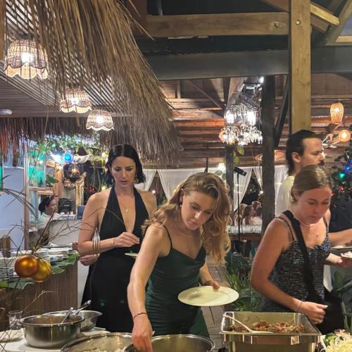 a group of women preparing food in a kitchen at Patrick's on the Beach Resort in General Luna