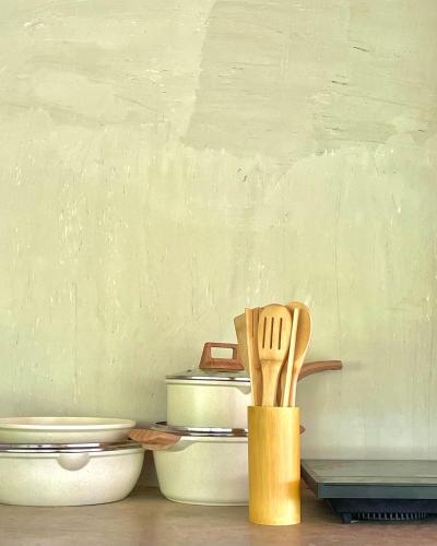 a wooden spatula sitting on a counter next to toilets at Patrick's on the Beach Resort in General Luna