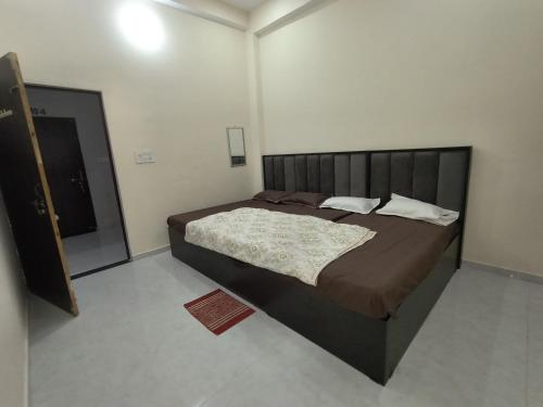 a bedroom with a large bed in a room at Pramod Residency in Chitrakoot
