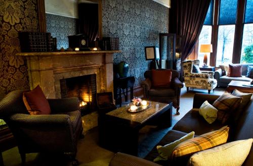 a living room with couches and a fireplace at One Devonshire Gardens a Hotel Du Vin in Glasgow