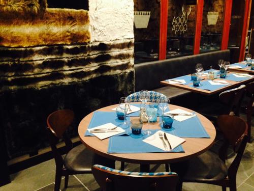 two tables in a restaurant with blue place settings at Résidence Odalys Edenarc in Arc 1800