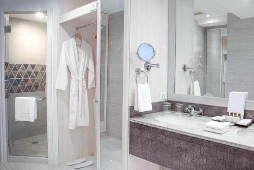 a bathroom with a sink and a shower at Vivere Hotel in Manila