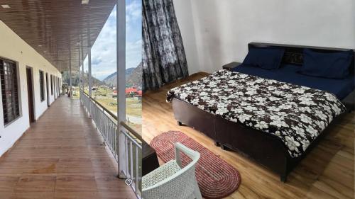 a bedroom with a bed and a large window at Swastik Hotel & Restaurant in Kharsālī
