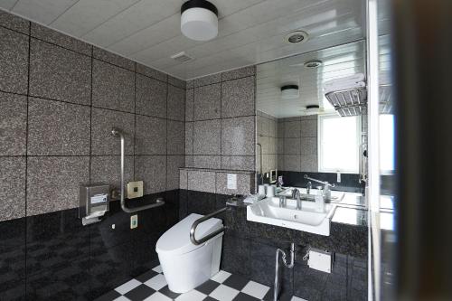 a bathroom with a toilet and a sink at Sotetsu Fresa Inn Fujisawa Shonandai in Fujisawa