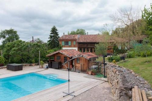 une maison avec une piscine en face de celle-ci dans l'établissement Chambres d'hôtes St Jacques Adults only, à Saint-Lizier