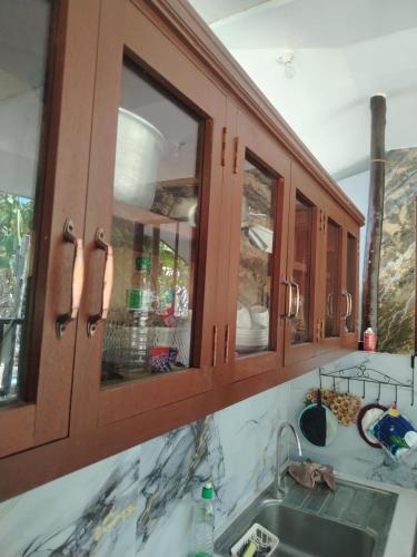 a kitchen with wooden cabinets and a sink at Mamatitas in San Vicente
