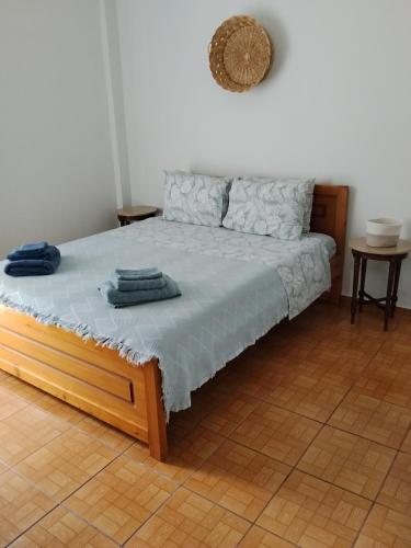 a bedroom with a bed with blue towels on it at Anastasia in Kyparissia