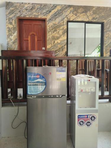 two refrigerators are sitting in a room with a window at Mamatitas in San Vicente