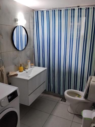 a bathroom with a sink and a shower curtain at Anastasia in Kyparissia