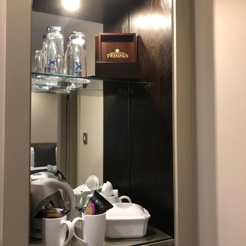 a room with a counter with cups and a box at Crown & Mitre Hotel in Carlisle