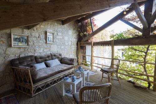 a living room with a couch and two chairs at La Tillaie SPA et Sauna in Pont-lʼAbbé-dʼArnoult