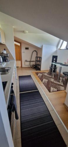 a kitchen with a long black carpet in a room at Aspen golf studio B402 in Razlog