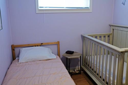 a small bedroom with a bed and a window at Bright & Spacious Full Family Home in Vancouver