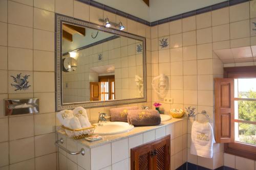 a bathroom with a sink and a mirror at Casa Font i Roig in Maria de la Salut
