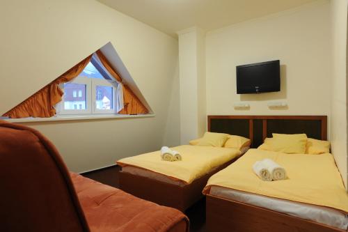 מיטה או מיטות בחדר ב-Wellness Penzion Jarmilka