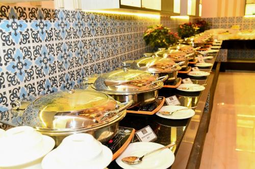 a buffet line with many pots and pans of food at Anarva Hotel & Spa in Mount Lavinia